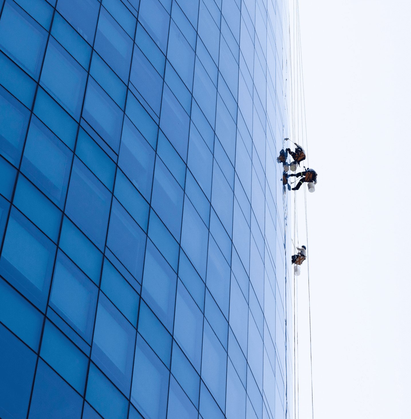 Rope access technicians working on a glass tower in Saudi Arabia